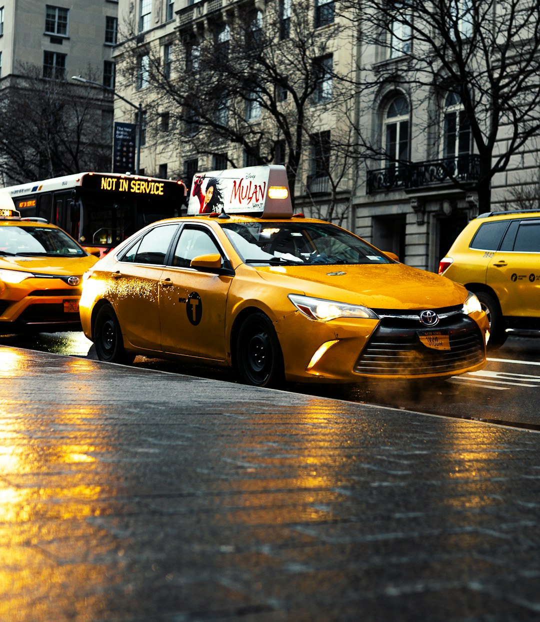 yellow-taxi-cab-on-road-during-daytime-xejmb1x3-um